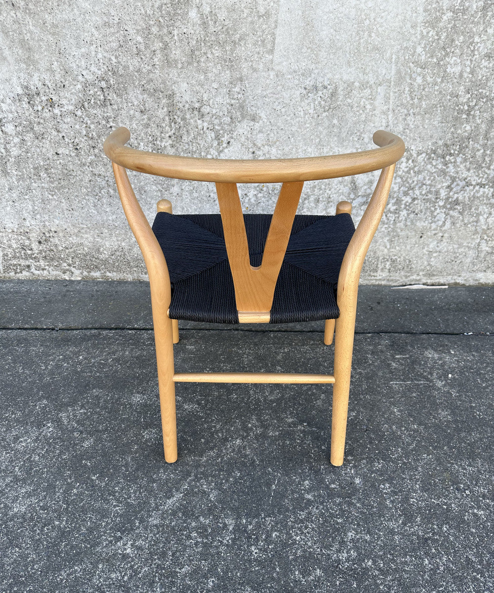 Wishbone Chair in natural and black, featuring a beech wood frame and rattan seat, perfect for modern and elegant decor.