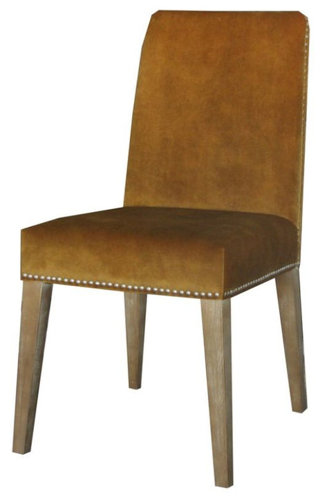 Luxurious dark mustard velvet dining chair with antique studs and solid timber frame, perfect for stylish dining spaces.
