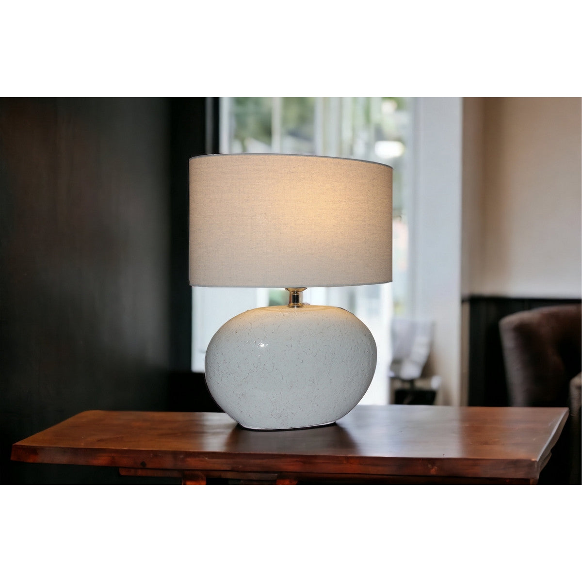 Elegant white terracotta lamp with natural linen shade, perfect for enhancing any space with modern aesthetics and warm light.