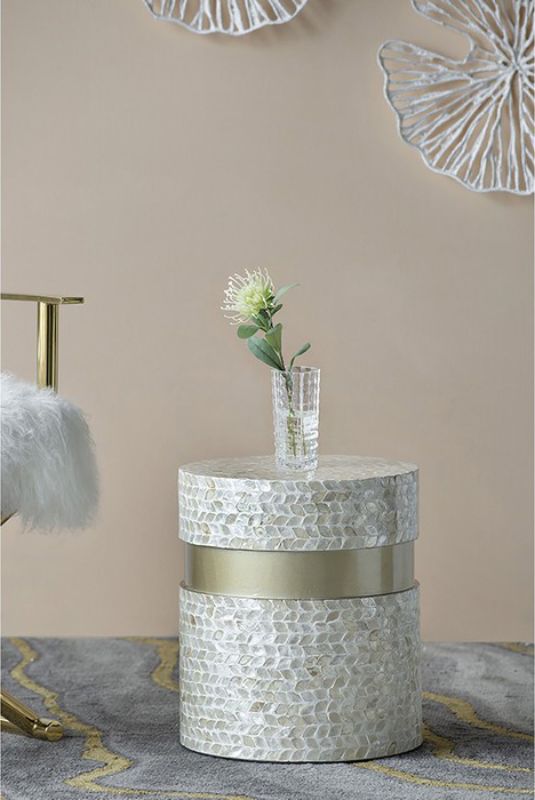 Geometric footstool in tan and gold, featuring capiz inlay and cylindrical design, perfect as a stylish accent or side table.
