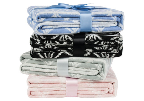 Soft acrylic knit throw in Serenity Blue and White, featuring a reversible geo pattern, perfect for cozy decor and stylish comfort.