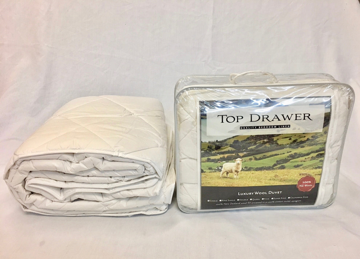 Luxurious queen-sized wool duvet inner (450gsm) offering year-round comfort with a soft cotton outer, ideal for a peaceful sleep.