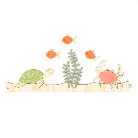 Colorful jigsaw-style ocean-themed wall art featuring a turtle and crab, perfect for kids' rooms, made from eco-friendly pine veneer.