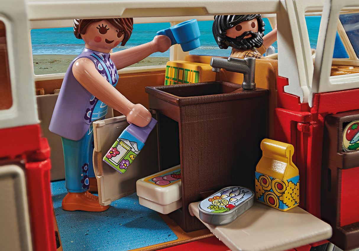 Playmobil Volkswagen T1 Camping Bus in red and white, featuring a detailed interior, removable roof, and two figures for imaginative play.