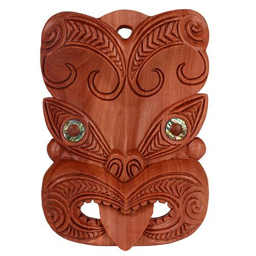 Large wooden tiki mask wall hanging, hand-carved from hardwood, symbolizing protection and ancestral spirits, adds cultural charm.