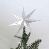 Elegant white 3D paper star tree topper with intricate cutouts for a beautiful holiday light display.