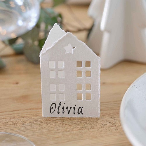 Charming white cotton paper house place cards for festive dining, eco-friendly and beautifully designed for holiday gatherings.