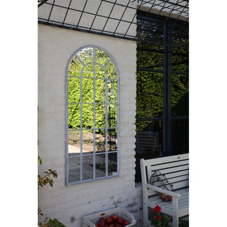 Metal outdoor mirror (140cm) with stained grey finish, inspired by Saxon windows, enhances garden aesthetics and space.