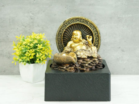 Water feature featuring a Lucky Buddha on coins, 25cm tall, with calming water flow and warm white light for tranquility.