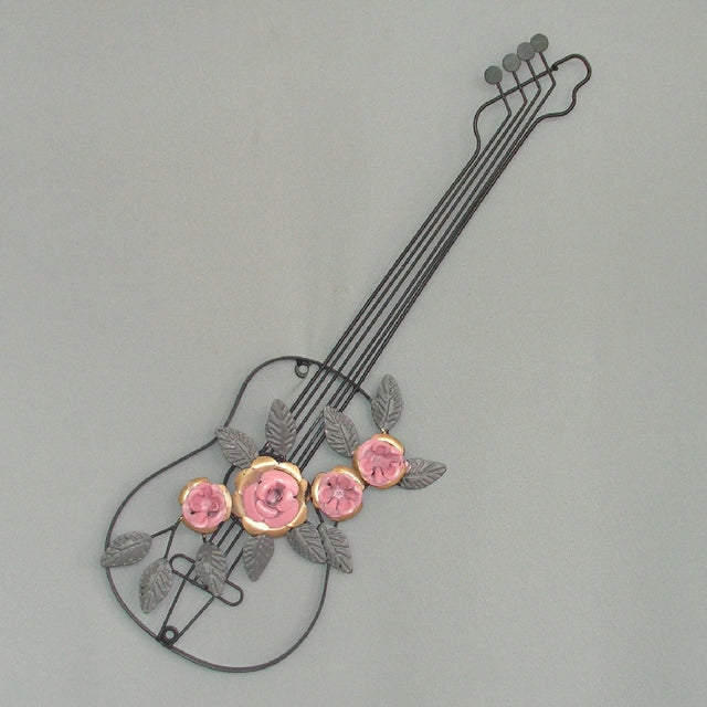 Guitar wall art featuring pink metal flowers, perfect for enhancing decor in homes and music studios.