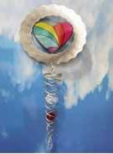 Colorful rainbow heart wind spinner for outdoor decor, perfect for gardens and patios, adds charm and whimsy.