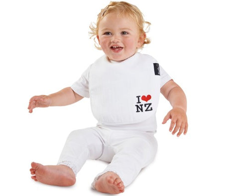 Kiwiana Wonder Bib in white with 'I Love NZ' print, designed for infants, features cotton, absorbent towelling, and water-resistant backing.