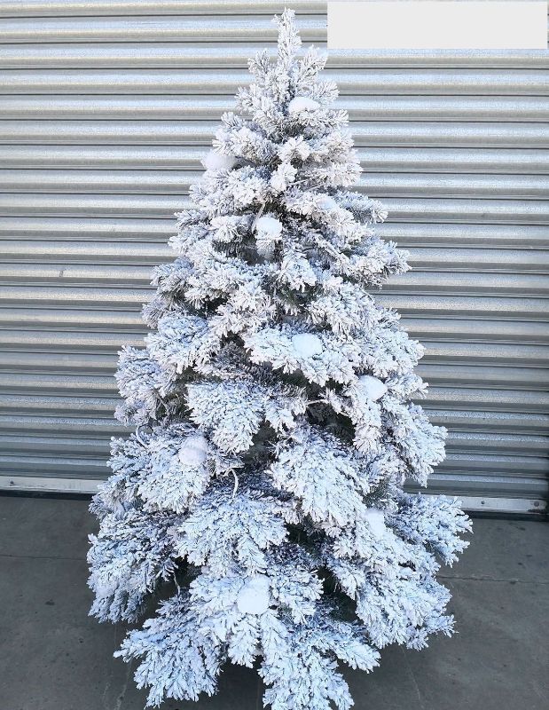 7.5' artificial snowy tree with warm LED lights, perfect for festive indoor or outdoor holiday decoration.