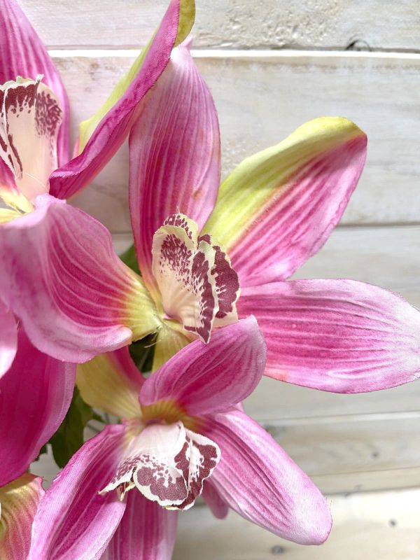 Lifelike pink artificial Cymbidium orchid bush, perfect for elegant home decor and versatile arrangements without maintenance.