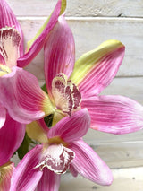 Lifelike pink artificial Cymbidium orchid bush, perfect for elegant home decor and versatile arrangements without maintenance.