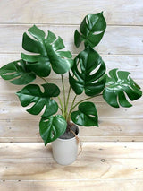 Lifelike green artificial monstera plant bush, perfect for adding tropical elegance to any indoor space without maintenance.