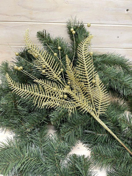 Artificial gold glittered fern spray, perfect for elegant floral arrangements and decor with a luxurious touch.