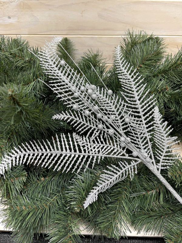 Artificial silver fern spray with glitter, ideal for elegant floral arrangements and home decor. Perfect for special occasions.