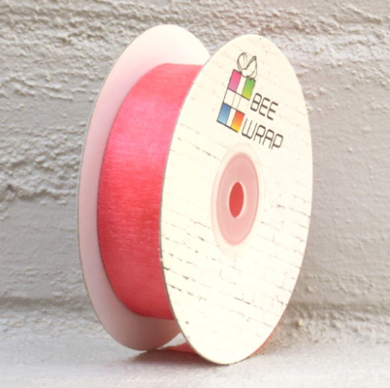 Peach organza ribbon, 25mm wide and 50m long, perfect for elegant gift wrapping and DIY crafts.
