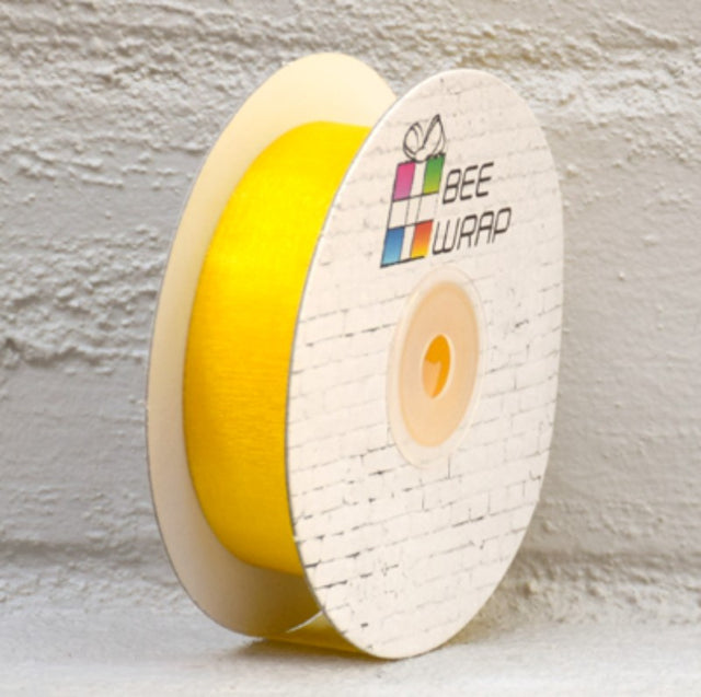 Vibrant yellow organza ribbon, 25mm wide and 50m long, perfect for crafts, gift wrapping, and elegant decorations.