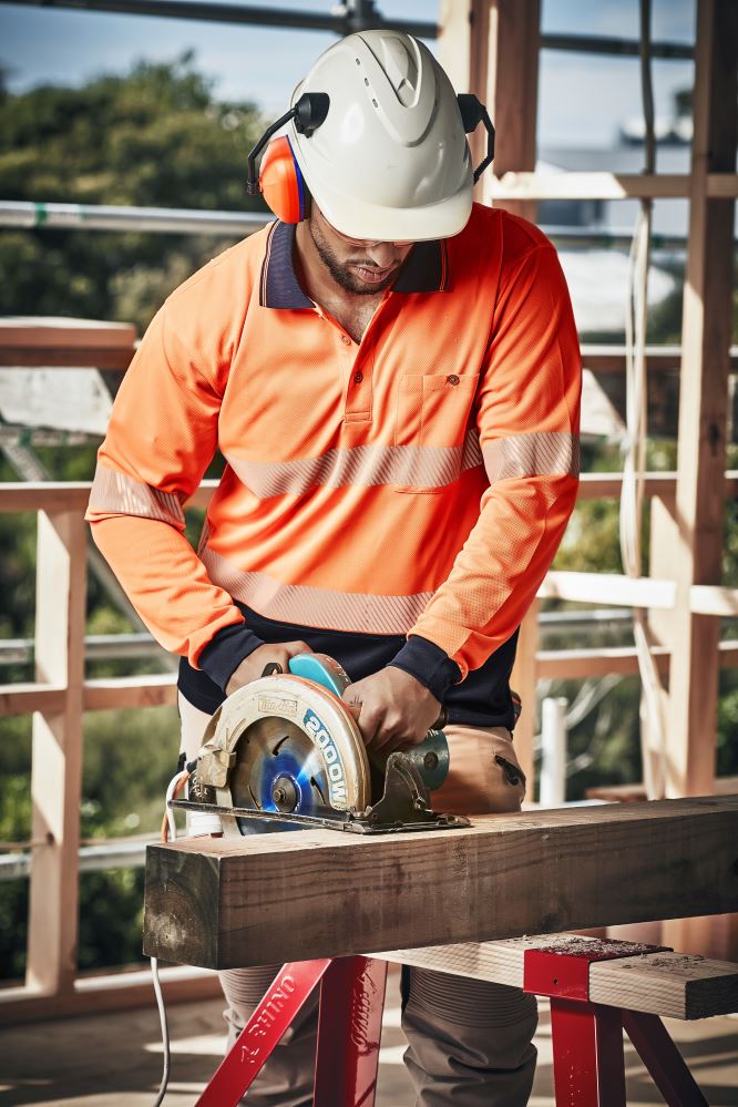 Unisex Hi-Vis segmented long sleeve polo in orange and navy, featuring moisture-wicking fabric and a chest pocket for essentials.