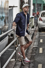Navy stretch shorts for men featuring 4-way stretch, multiple pockets, and reflective details for comfort and functionality.