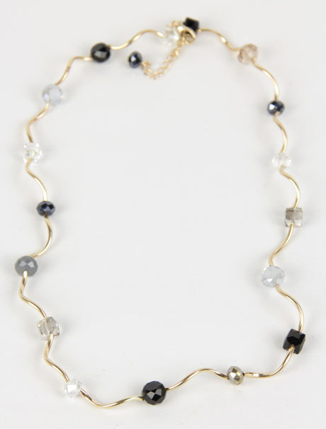 Sleek black Ripple Necklace with 18-inch length and 3-inch extension, perfect for layering or minimalist styling.