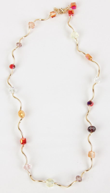 Ripple Necklace in vibrant orange with elegant ripple design, adjustable length, perfect for any occasion.