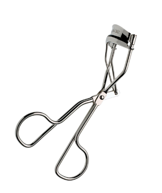 Manicare Eyelash Curler in stainless steel with silicone pad for beautifully curled lashes, includes a spare pad for longevity.