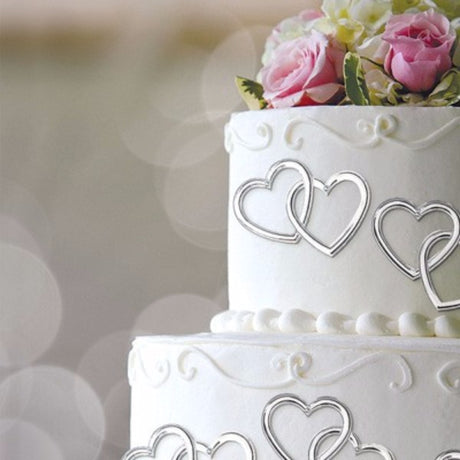 Silver heart-shaped cake topper picks, 7.8cm x 9.3cm, perfect for decorating cakes and cupcakes for any celebration. Pack of 12.