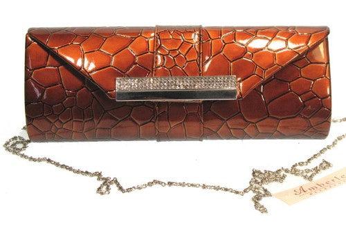 Chic red evening bag with sleek silhouette and long metal detail, perfect for formal events and stylish nights out.