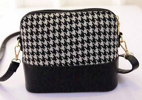 Chic black and white shoulder bag, compact yet spacious, perfect for day-to-night transitions and everyday essentials.