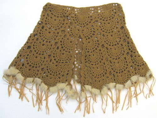 Camel poncho with luxurious fur trim and tassels, perfect for stylish winter layering.