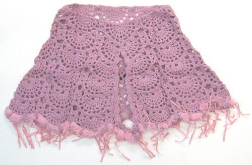 Pink poncho with luxurious fur trim and playful tassels, perfect for stylish layering and cozy chic fashion.