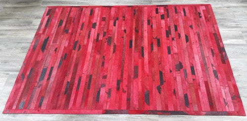 Handmade cowhide leather rug with vibrant red stripes, measuring 1.38 x 1.97m, perfect for modern home decor.