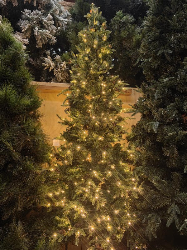 7' slim artificial pine tree with 1412 tips and pinecones, perfect for festive decor in small spaces.