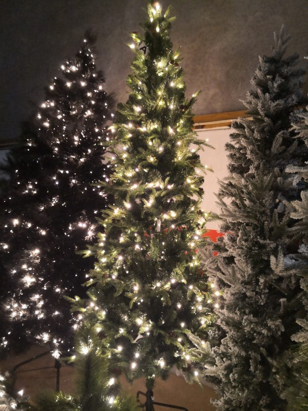 7' Slim Pine Christmas tree with 1412 tips and pinecones, perfect for small spaces and creating a festive atmosphere.