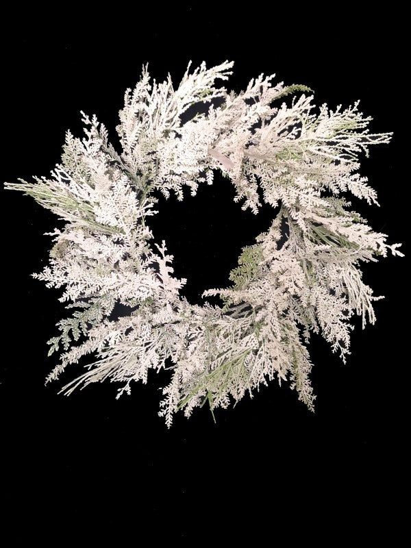24" Snowy Cedar Wreath featuring lifelike snowy foliage, perfect for festive home decor and lasting holiday ambiance.