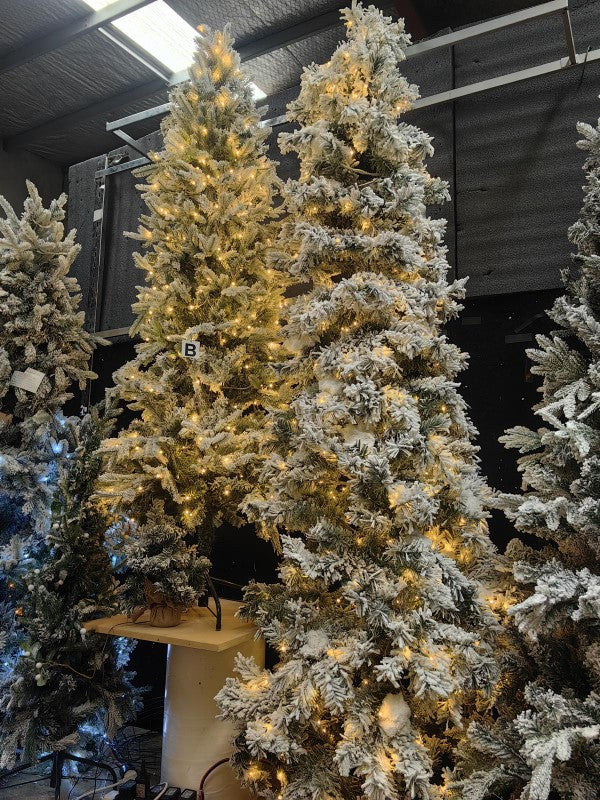 8' heavy snow slim pine tree adorned with 600 warm white LED lights, featuring realistic snowy branches for festive decor.