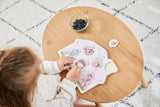 Colorful wooden peg puzzle shaped like a house, featuring Fairy-Princess Lillie and friends, designed for toddlers' play.