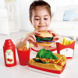 Hape Fast Food Set with a lifelike burger, hotdog, fries, and cola for imaginative play and social skill development.