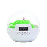 Golf ball-shaped alarm clock (10cm) with integrated putting game to silence the alarm for a fun wake-up experience.