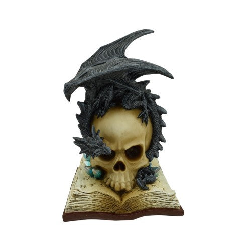 Ornate skull on an ancient book, with a black dragon, glowing eyes add mystique to gothic home decor.