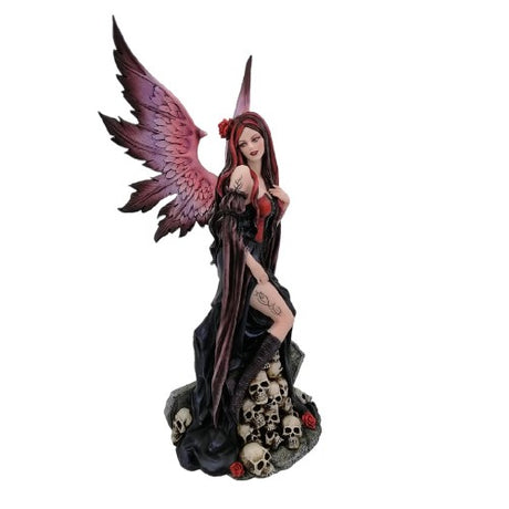 Gothic Girl perched atop detailed skulls, a hand-painted resin ornament for dark aesthetic home decor.