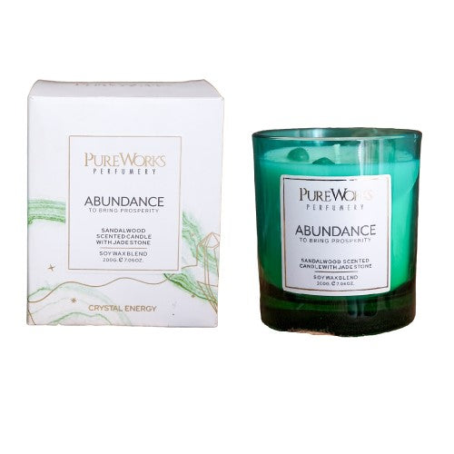 Abundance Sandalwood candle in an ombre jar with jade crystal, promoting prosperity and offering a soothing 50-hour burn.
