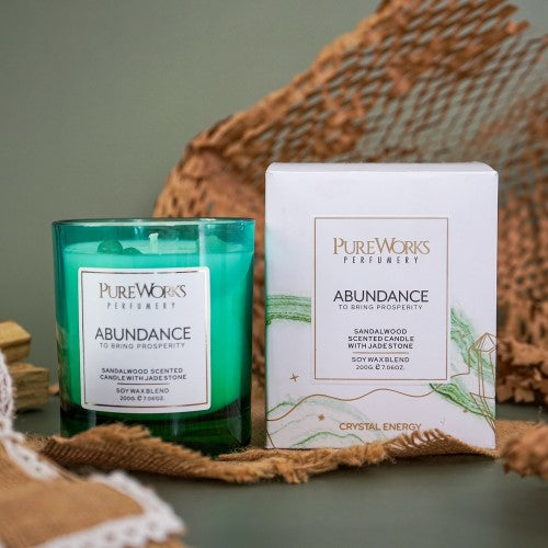 Abundance Sandalwood candle in an ombre jar, infused with jade crystal for prosperity and a 50-hour eco-friendly burn.