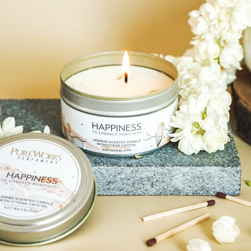 Happiness Jasmine Candle in a sealed tin with Citrine crystals, promoting positivity and calm with a 10-hour burn time.