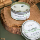 Abundance Sandalwood candle with jade crystal in a decorative tin, promoting tranquility and attracting prosperity.