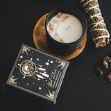 Black frosted glass candle with myrrh and sandalwood scents, gemstone chips, and eco-friendly soy wax, perfect for mindfulness.