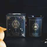 Eye of Providence candle in black frosted glass features sage and white tea scent, gemstone chips, and 20-hour burn time.